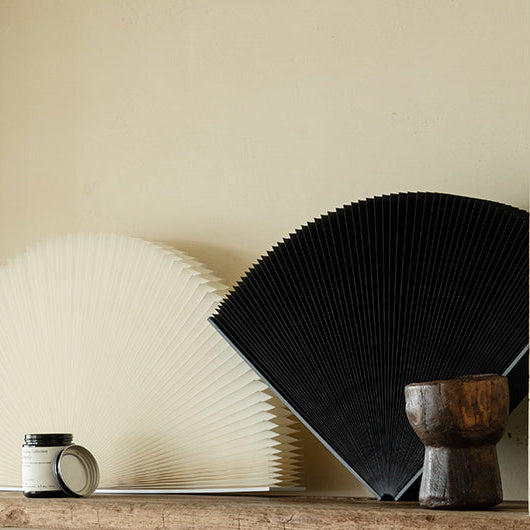 Foldable Pleated Paper Fan Decor in a modern living room setting with natural light