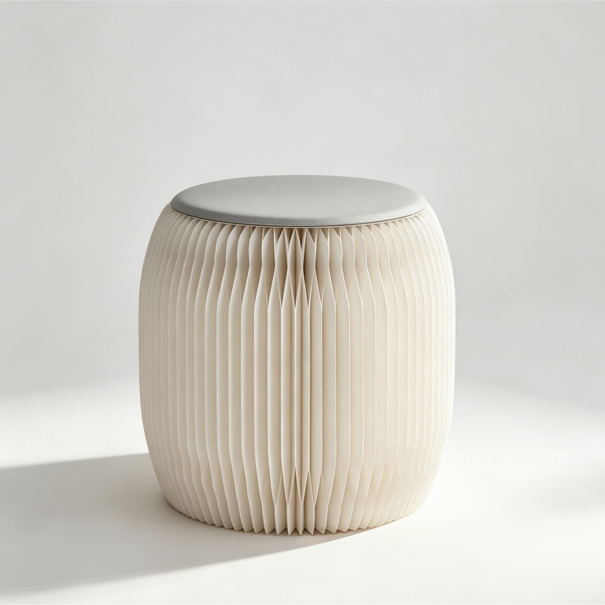 White round foldable honeycomb paper stool on a neutral background