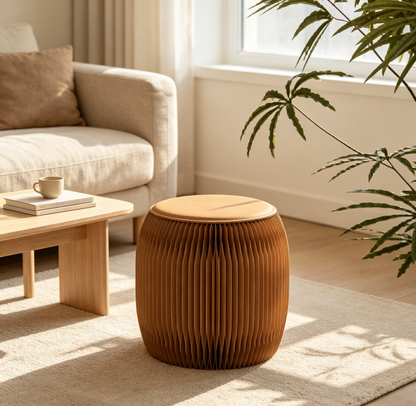 Round brown paper stool beside a sofa in a sunlit interior