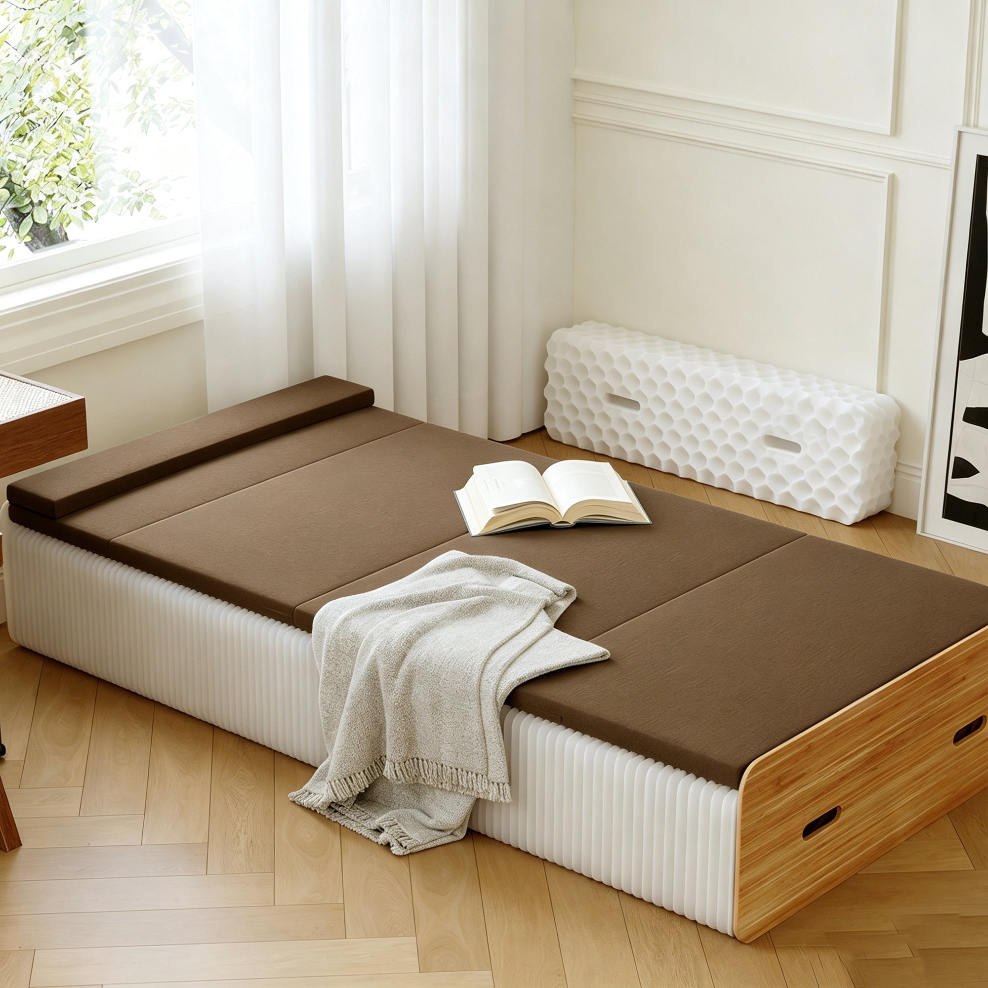 Close-up of brown foldable paper bed with mattress and open book – core benefits of paper folding beds