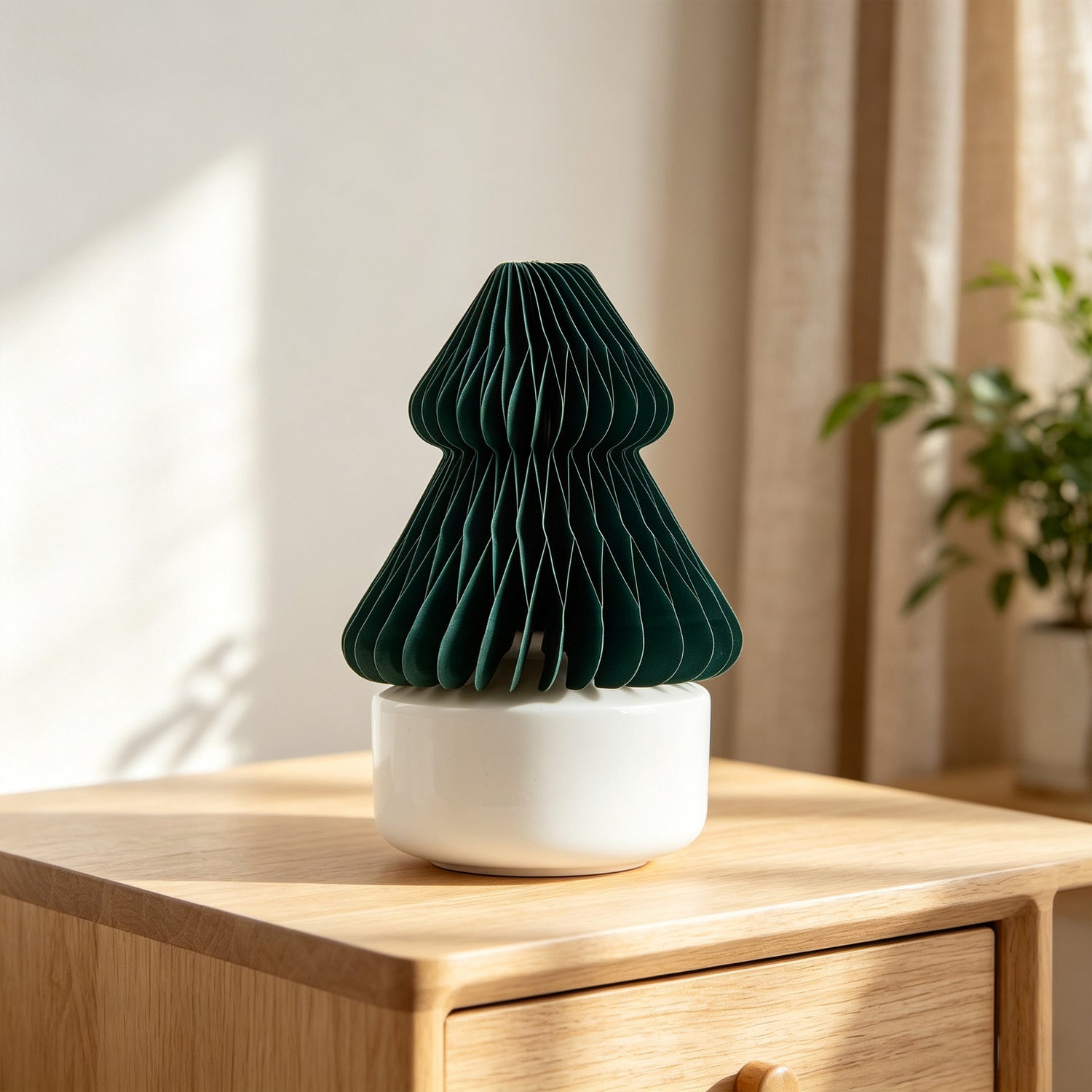 Dark green honeycomb paper Christmas-tree shaped fragrance diffuser on wooden dresser – extending fragrance brands beyond conventional formats