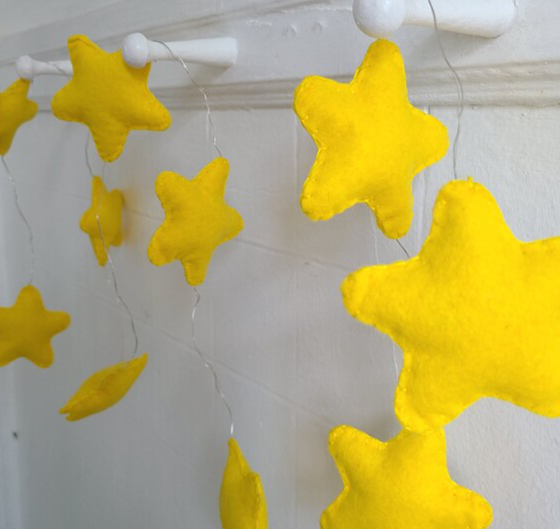 Yellow felt star covers for decorative string lights