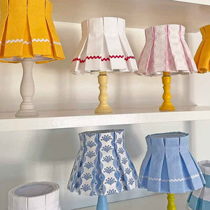 Geometric diamond-shaped origami paper lampshade in soft lighting