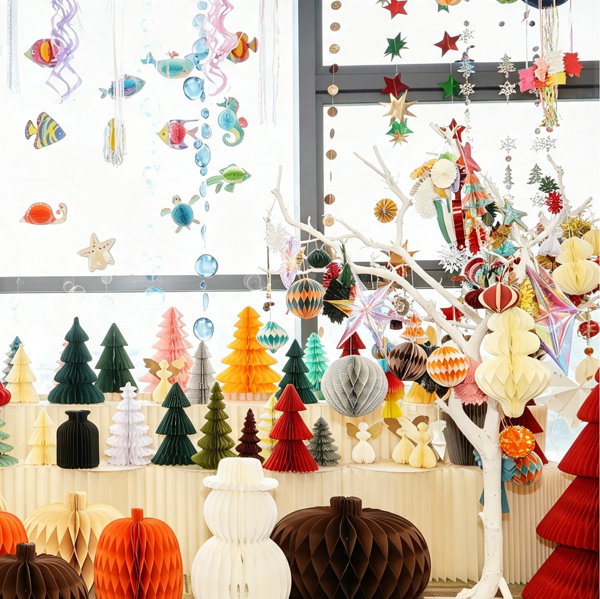 Paper lighting prototypes including honeycomb trees and decorative forms