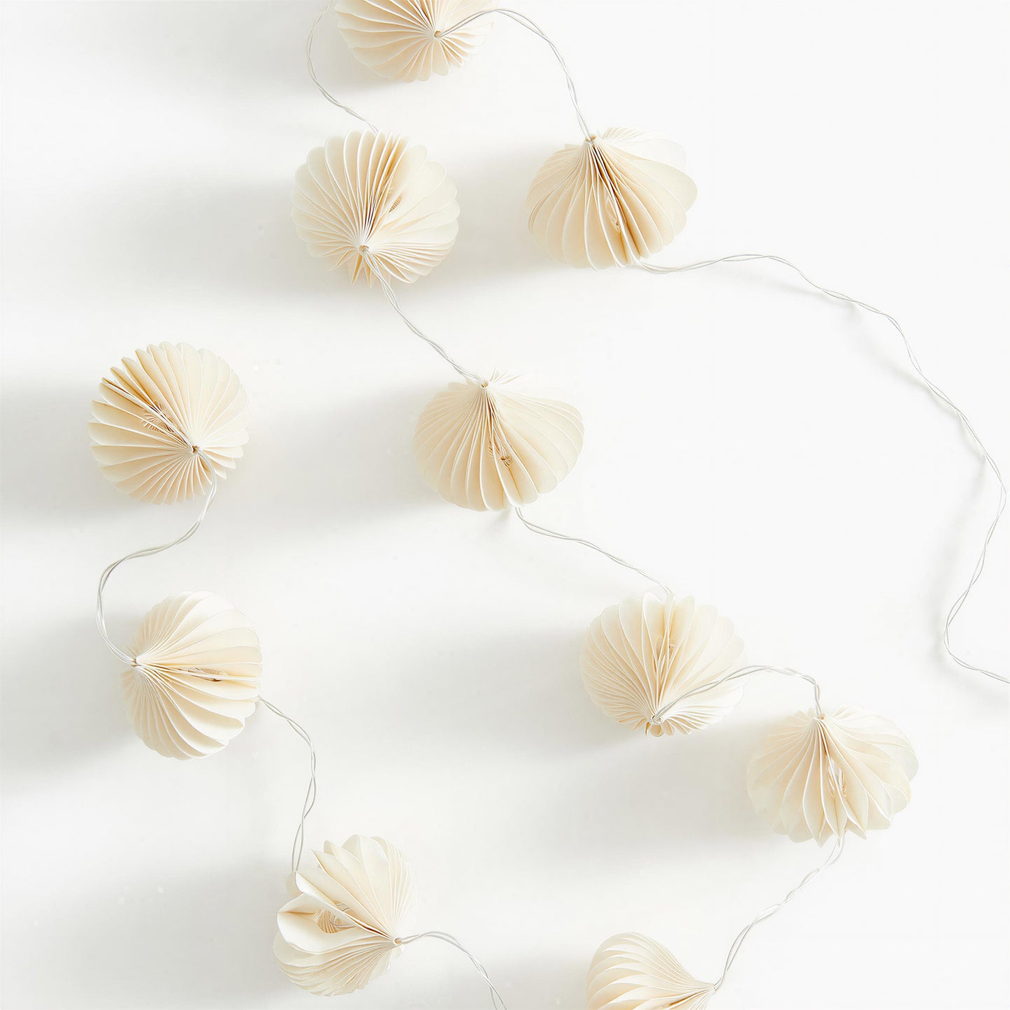 Cream Flower-Shaped Honeycomb Paper String Lights on a white background