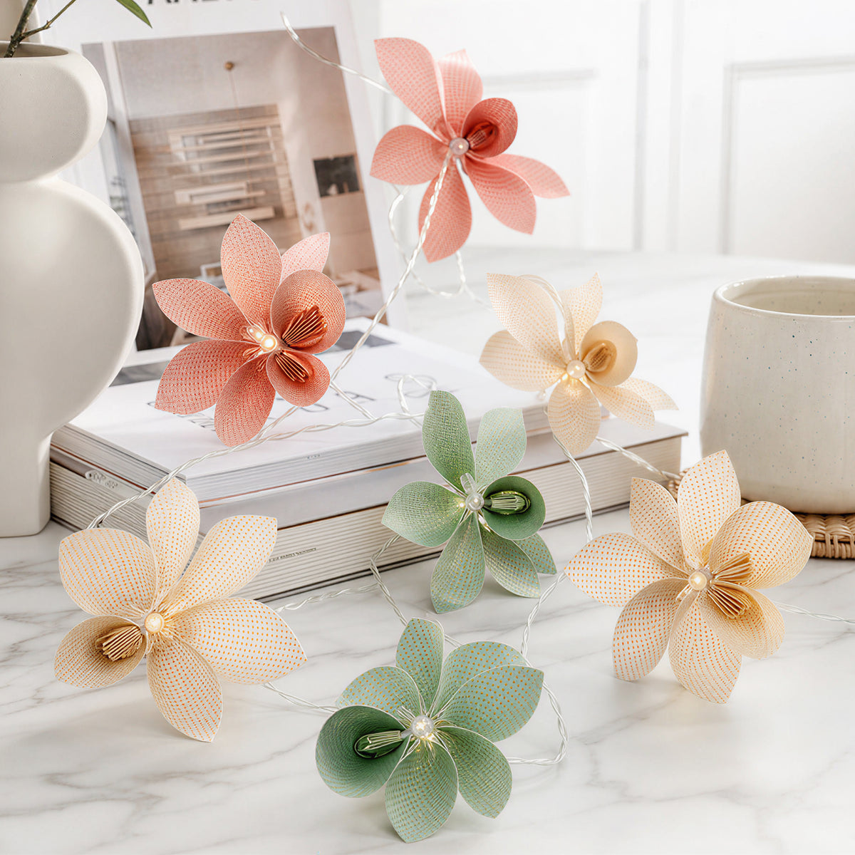 Folded Multicolor Perforated Paper Flower String Lights for compact storage and shipping