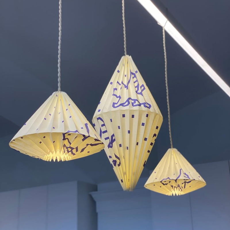 Group of colorful patterned origami paper pendant lampshades on display