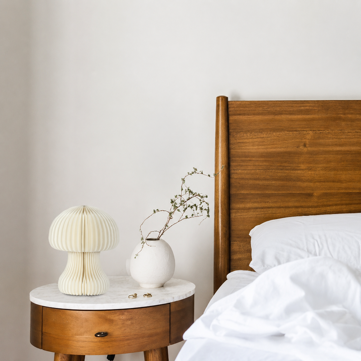 White honeycomb paper table lamp on marble nightstand in minimalist residential bedroom interior