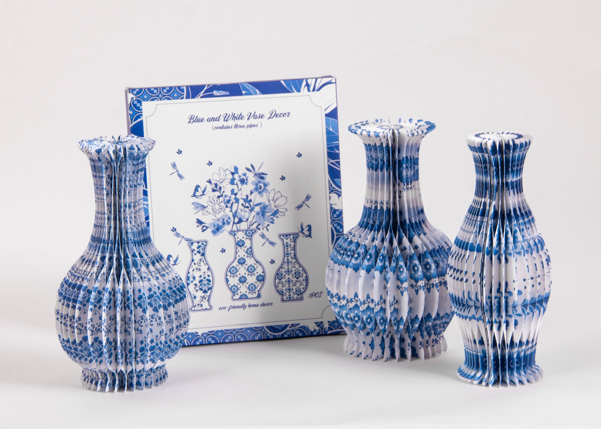 Blue and white patterned honeycomb paper vase next to matching decorative packaging – core benefits of paper vases