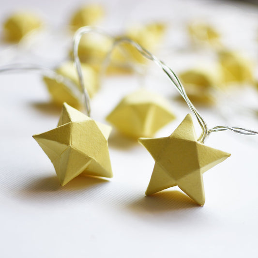 Yellow Origami Paper Star String Lights on a white background