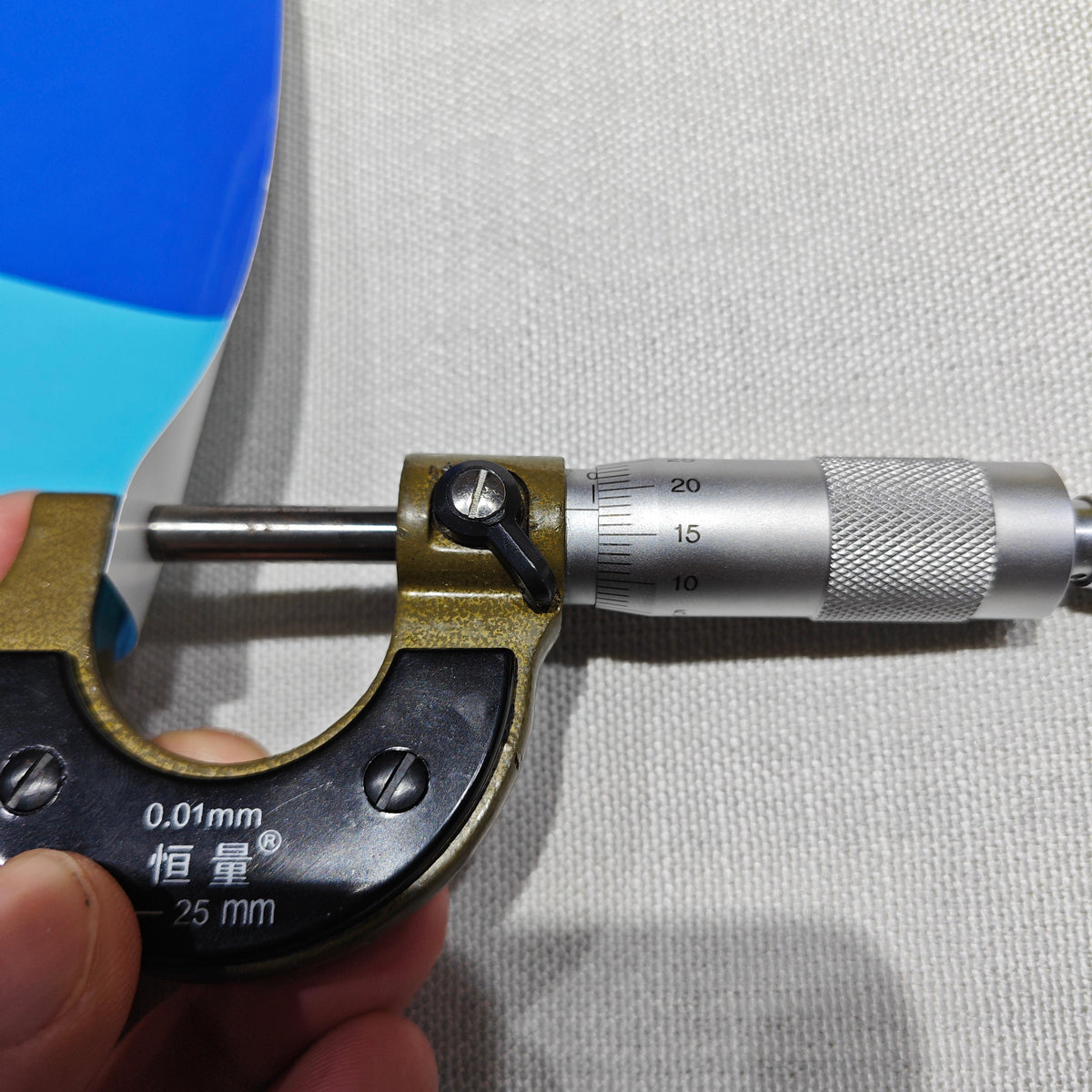 Micrometer measuring paper material thickness – quality control for custom paper decor and gift manufacturing