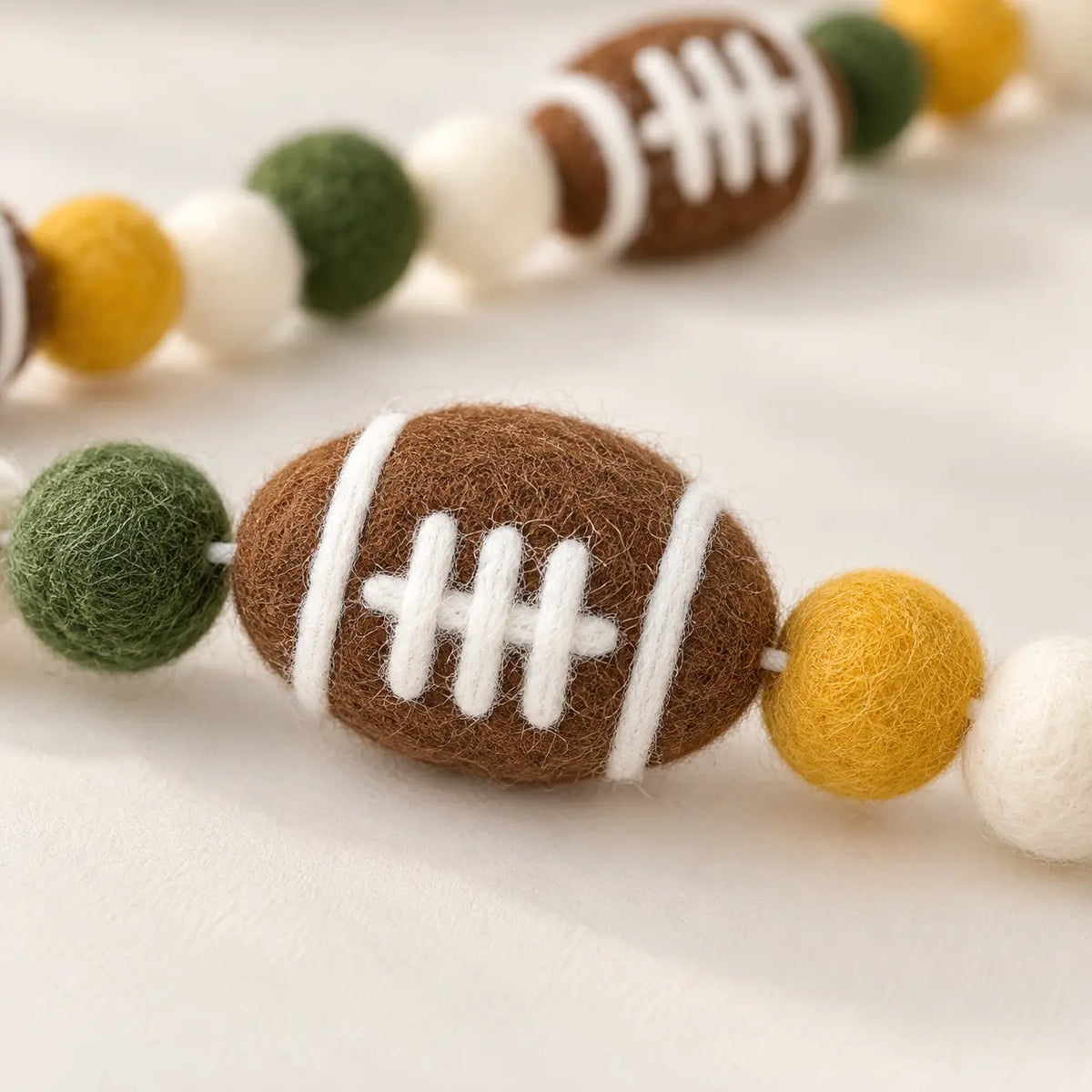 Felt American Football Garland with Pom-Pom Balls showing its structure