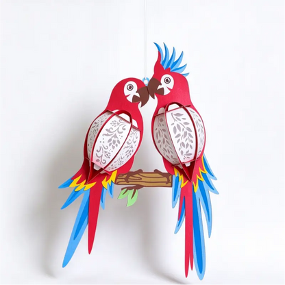 Illuminated lovebird parrot paper hanging lantern with warm decorative cutout panels