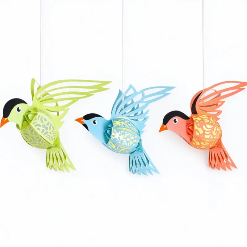Colorful LED paper bird lanterns hanging beside a bright nursery window