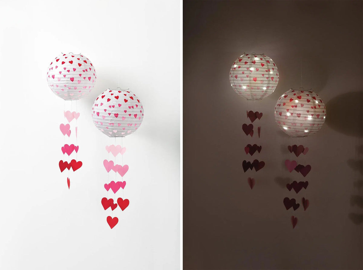 Two Valentine’s Day paper lanterns with red and pink cascading heart decorations